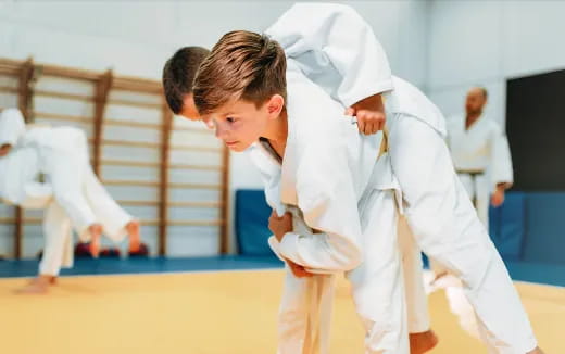 a couple of people in karate uniforms