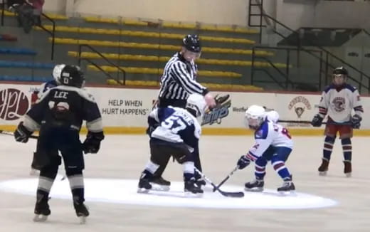 a group of people playing hockey