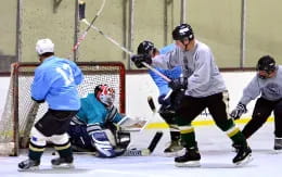 a group of people playing hockey