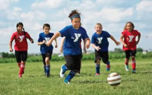 a group of kids playing football