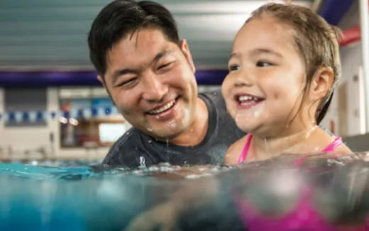 a person and a child in a pool