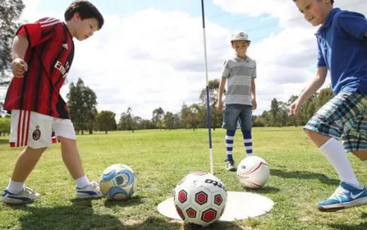 a group of kids playing football