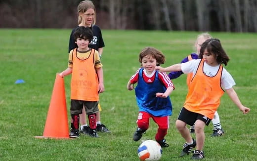 kids playing football on a field