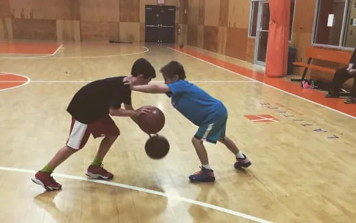 a couple of boys playing basketball