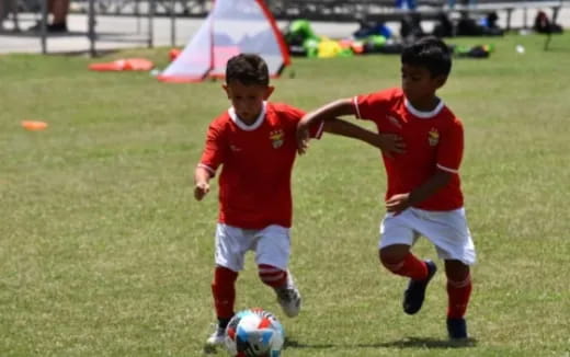 a couple of young boys playing football