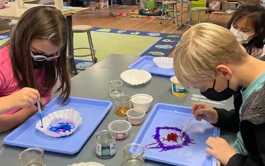 a group of children painting