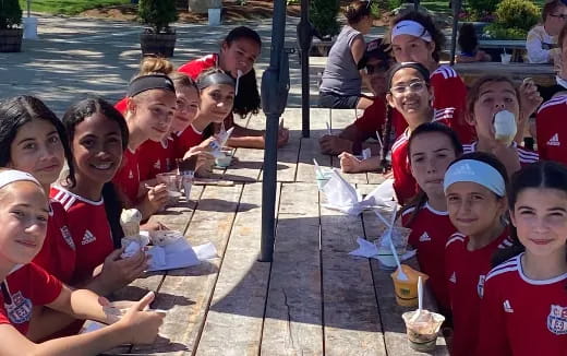 a group of children sitting at a table