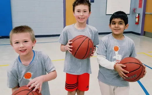 a group of boys holding basketballs