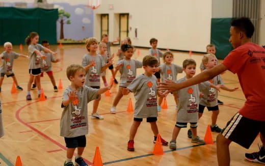 a group of kids playing basketball