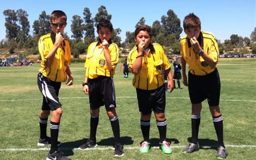 a group of boys in yellow uniforms