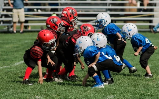 a group of kids playing football