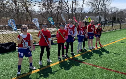 a group of people in red uniforms on a track