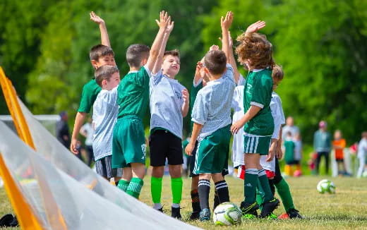 a group of kids playing football