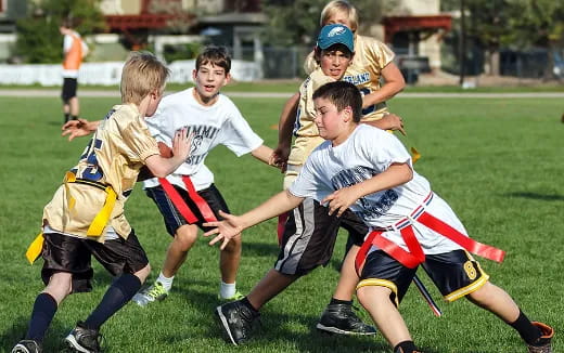 a group of kids playing rugby