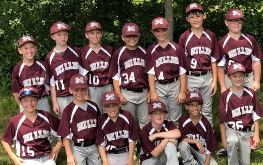 a group of kids wearing baseball uniforms