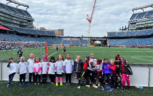 a group of people posing for a photo in a stadium