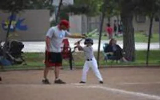 a kid swinging a baseball bat