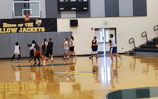 a group of people playing basketball