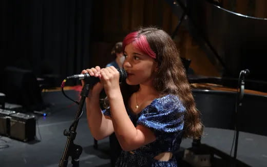 a woman singing into a microphone