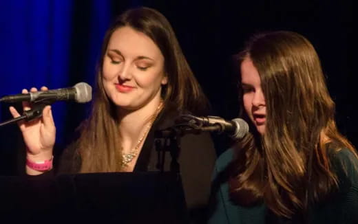 a woman singing into a microphone