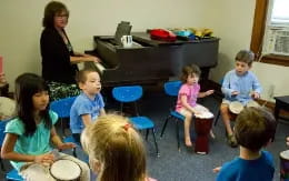 a group of children sitting in chairs