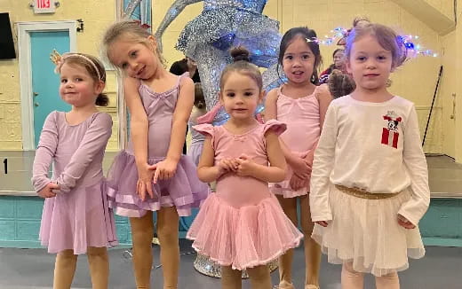 a group of girls in dresses