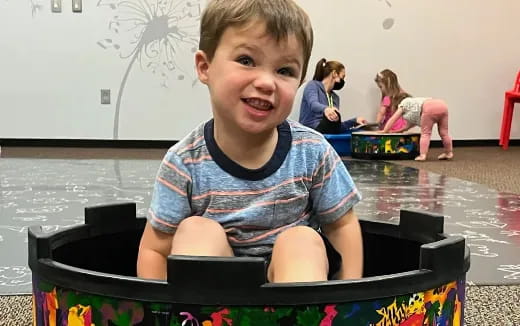 a boy sitting in a chair