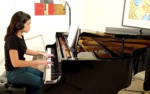 a woman playing a piano