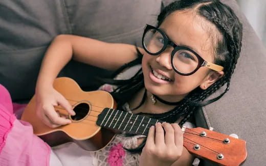 a girl playing a guitar