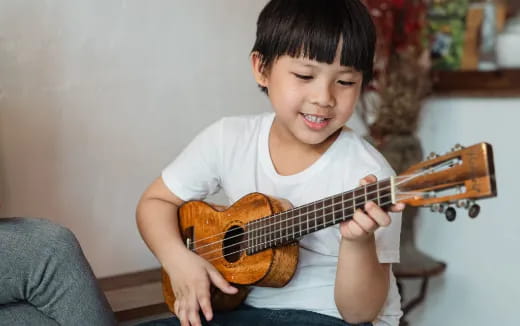 a boy playing a guitar