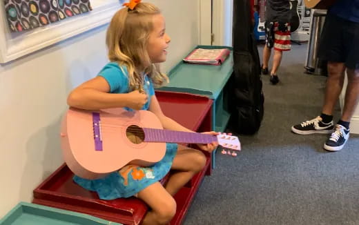 a girl sitting on a bench