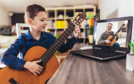 a boy playing a guitar