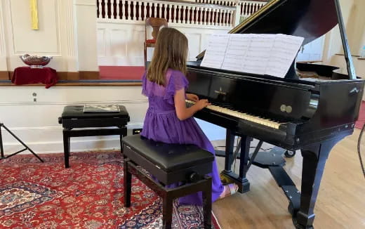 a woman playing a piano