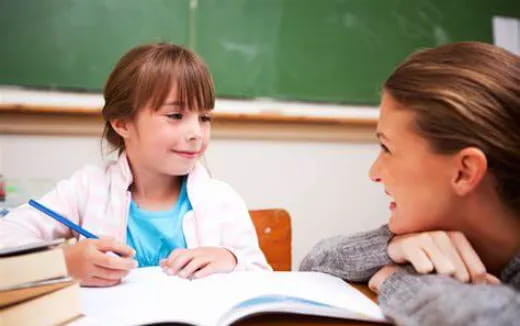 a young girl and a young girl studying in a classroom