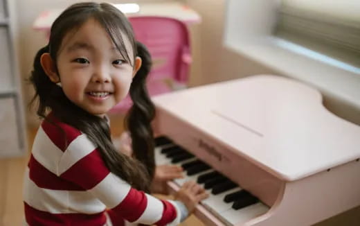 a girl playing a piano