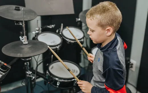 a boy playing drums
