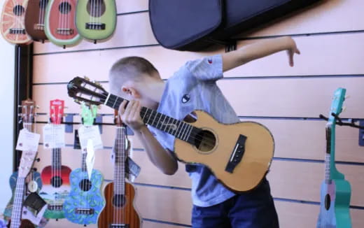 a boy playing a guitar