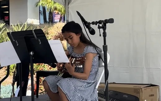 a woman playing the piano