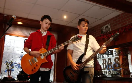 two men holding guitars