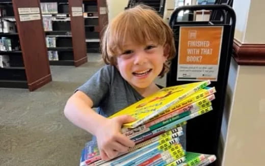 a boy holding a book