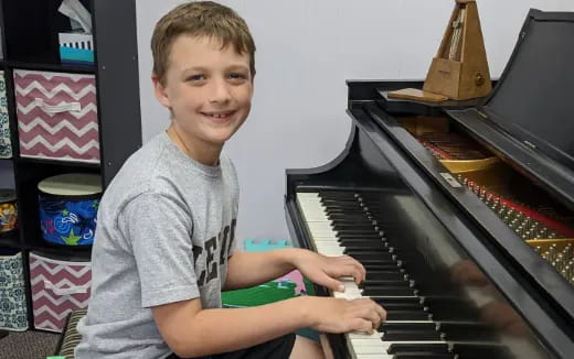 a boy playing a piano