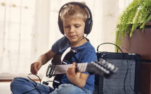 a boy playing a guitar