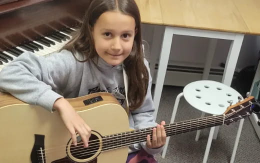 a girl playing a guitar