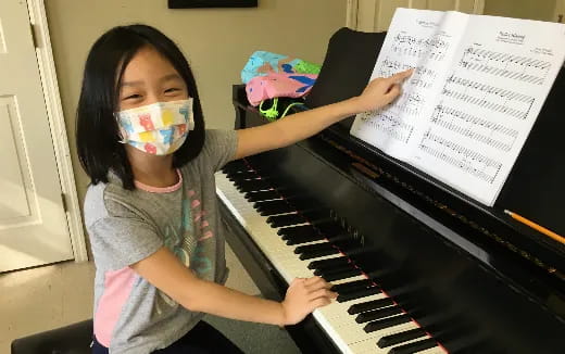 a girl playing a piano