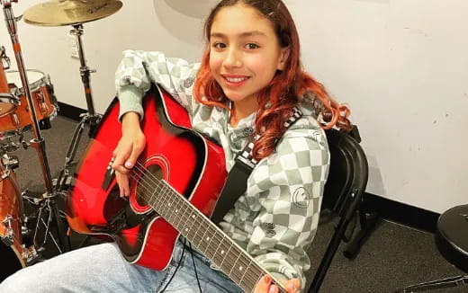 a girl playing a guitar