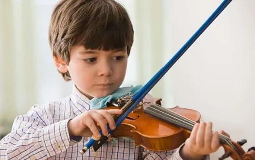 a boy playing a violin