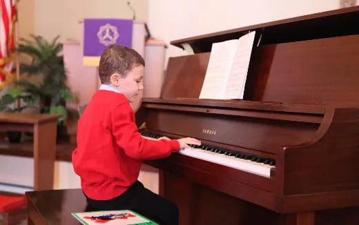 a boy playing a piano