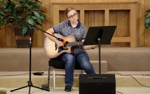 a woman playing a guitar