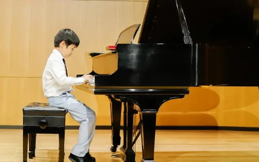 a boy playing a piano