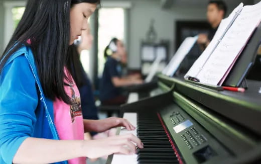 a woman playing a piano